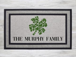 Mockup of custom welcome doormat that features your last name under a large shamrock made up of smaller shamrocks.