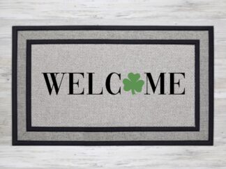 Mockup of a St. Patrick's Day themed welcome mat featuring the phrase, "WELCOME" with a green shamrock in place of the letter 'O'