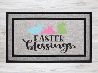 Mockup of an Easter themed doormat that features the phrase "Easter Blessings" with a trio of adorable bunnies above the phrase