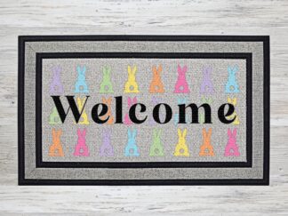 Mockup of an Easter themed doormat that features the word "Welcome" over a number of pastel colored bunny rabbits