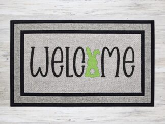Mockup of an Easter themed doormat that features the phrase "Welcome" with a cute bunny in place of the 'O' in "Welcome'
