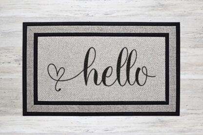 Mockup of a welcome doormat that says "hello" in a bold cursive font that ends with a heart flourish