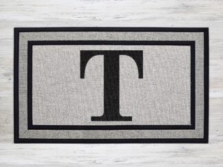Mockup of a custom welcome doormat that features the your last name's first initial as a monogram in a simple bold serif font