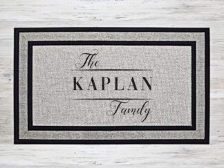 Mock up of a personalized welcome mat featuring your last name in a beautiful black font