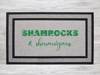 Mockup of a St. Patrick's Day themed welcome mat featuring the saying "shamrocks & shenanigans"