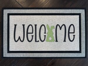 Client photo of an easter themed Welcome mat with a bunny in place of the 'O' in Welcome