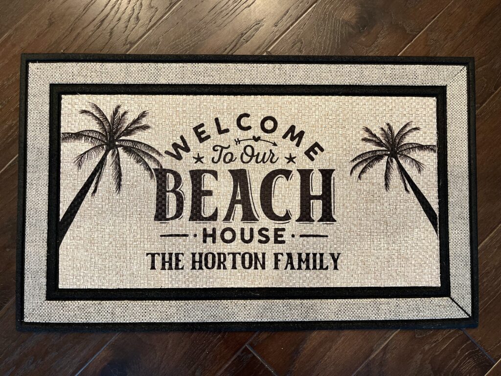 Photo of a custom Beach House doormat with palm trees for the Horton family