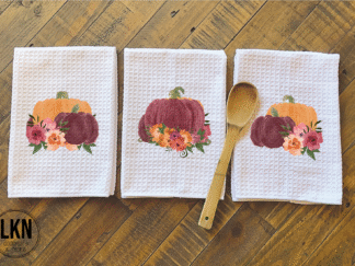 Set of three fall dish towels with burgundy and orange pumpkins and autumn flowers