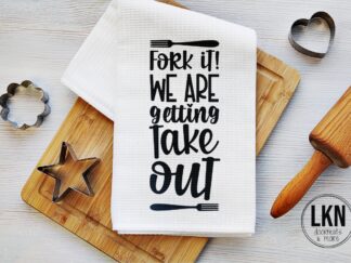 Funny dish towel with bold text: 'Fork it! We're getting take out!' written in bold black on a white background.