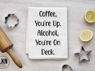 Text on dish towel: 'Coffee you're up. Alcohol you're on deck.' - A humorous reminder of the day's beverage lineup.