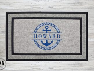 Blue rope encircles an anchor with last name on a doormat, creating a nautical theme for a personalized touch.