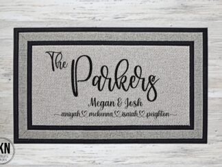 Doormat: Large handwriting font displaying last name. Below: Couple's first names & children's names. A personalized welcome for the whole family.