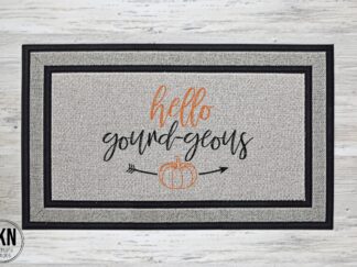Mockup of a doormat that reads, Hello Gourd-geous, with a small pumpkin underneath the text