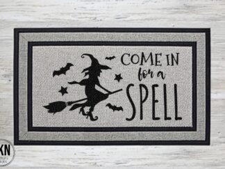 Mockup of a Halloween themed doormat that says "Come in for a Spell" with a witch flying on a broom.