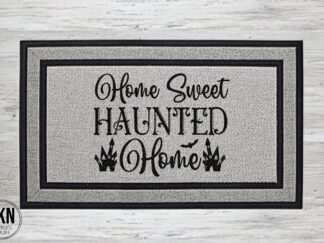 Mockup of a Halloween themed doormat that says "Home Sweet Haunted Home" in a bold black font with a pair of haunted houses flanking the word home.
