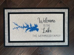 Photo of a doormat for a client at Lake Murray in South Carolina, for the Weyhmuller family, that says "Welcome to the Lake, The Weyhmuller Family" with a cartography map of Lake Murray.