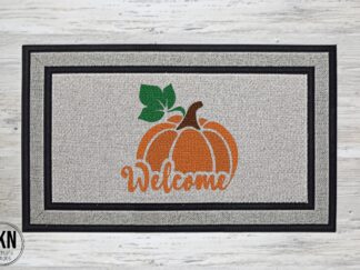 Mockup of a doormat that says "welcome" merged into the bottom of a pumpkin.