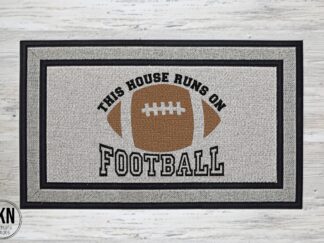Mockup of a Football themed doormat that says "This House Runs on Football" in a bold black font with a football in the center