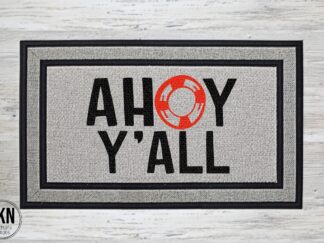 Mockup of a nautical themed welcome doormat that says, "ahoy y'all" in a bold black font with a life preserver.
