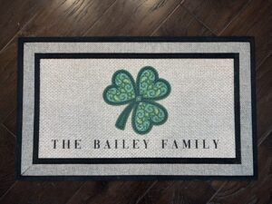 Client photo of a Mandala Shamrock doormat that says "The Bailey Family"