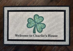 Client photo of a Mandala Shamrock doormat that says "Welcome to Charlie's House"