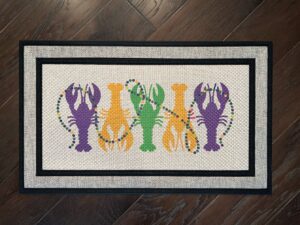 Photo of client order of a Mardi Gras themed doormat featuring crawfish & beads
