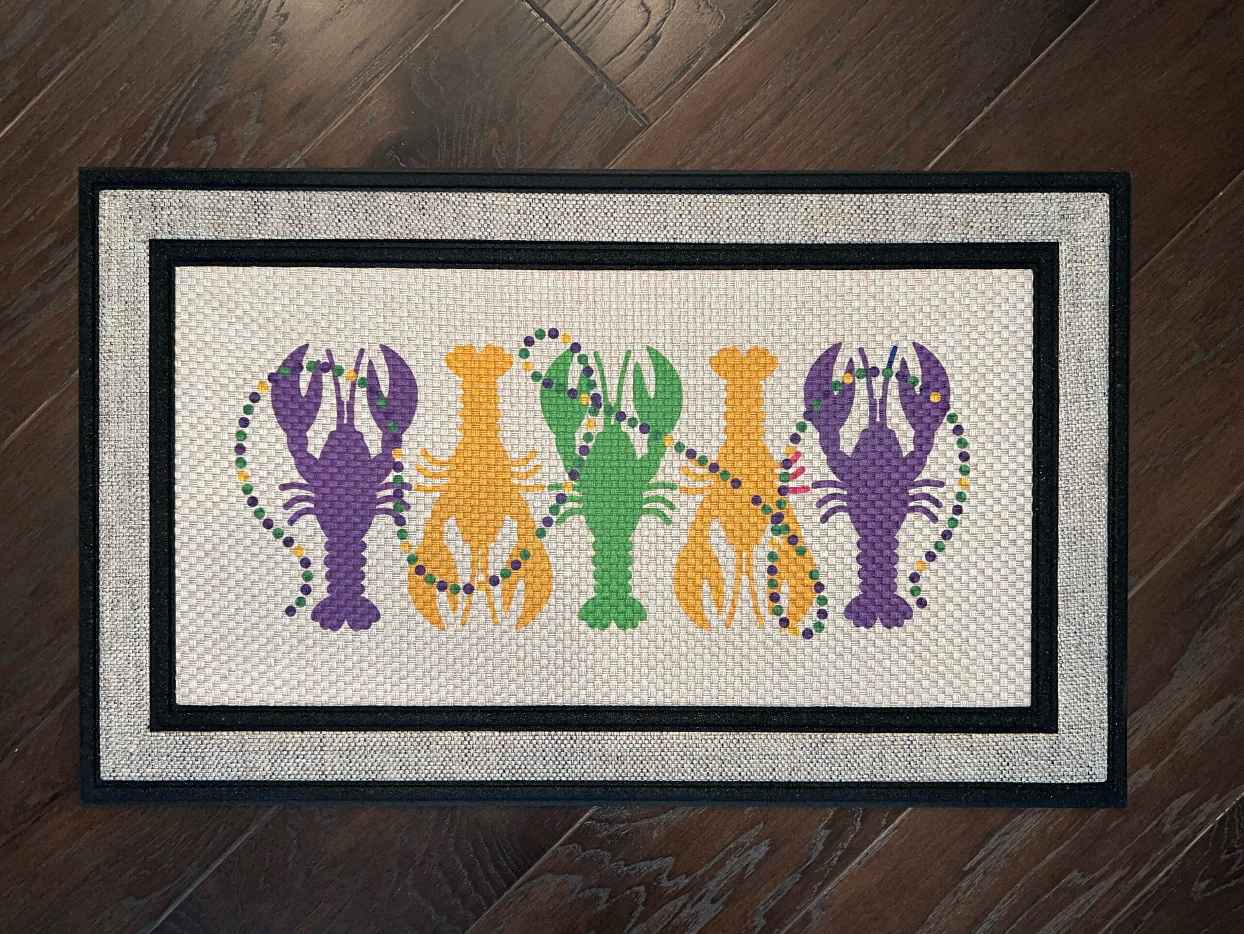 Photo of client order of a Mardi Gras themed doormat featuring crawfish & beads
