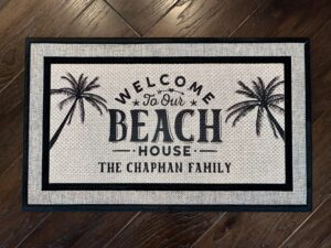 Client picture of a beach themed doormat that reads Welcome to our Beach House, The Chapman Family.