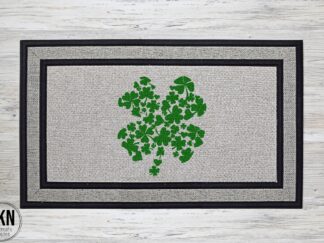 Mockup of a saint patrick's day themed doormat featuring a shamrock that is filled with smaller shamrocks in a beautiful kelly green color.