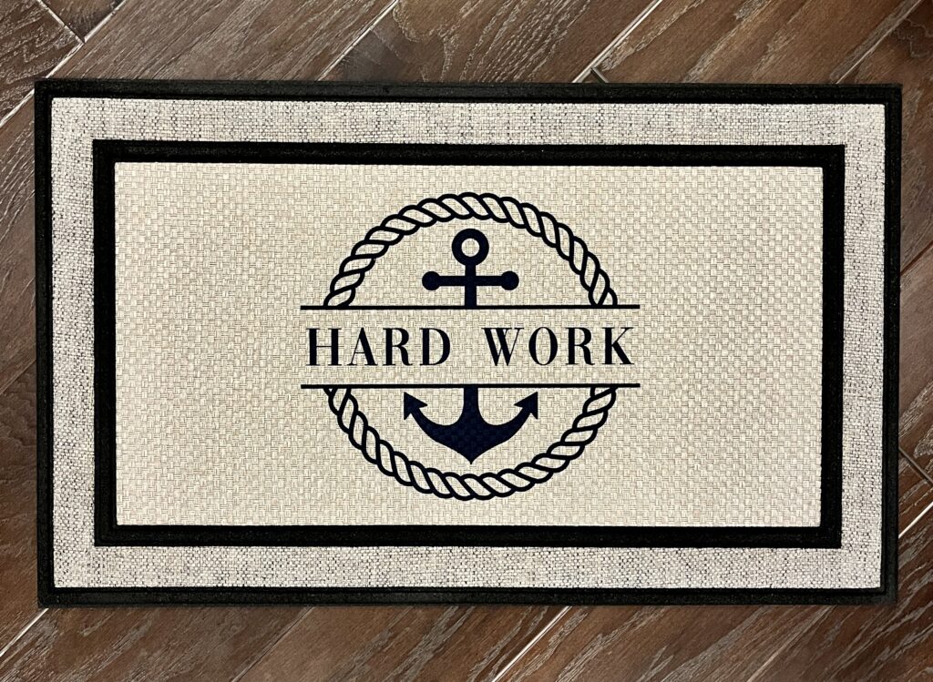 Client photo of our nautical inspired doormat featuring the boat name of the client's friend's new boat, Hard Work
