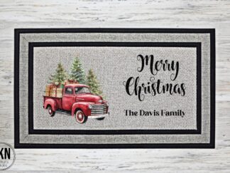 Custom Christmas doormat with vintage red farm truck, 'Merry Christmas' text, and personalized family name option. Festive holiday decor for welcoming guests. Durable and charming holiday entryway accessory.