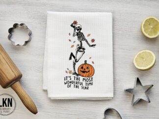 Halloween dish towel with skeleton and phrase It’s the Most Wonderful Time of the Year