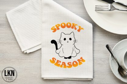 Halloween dish towel with cat dressed as ghost and Spooky Season text